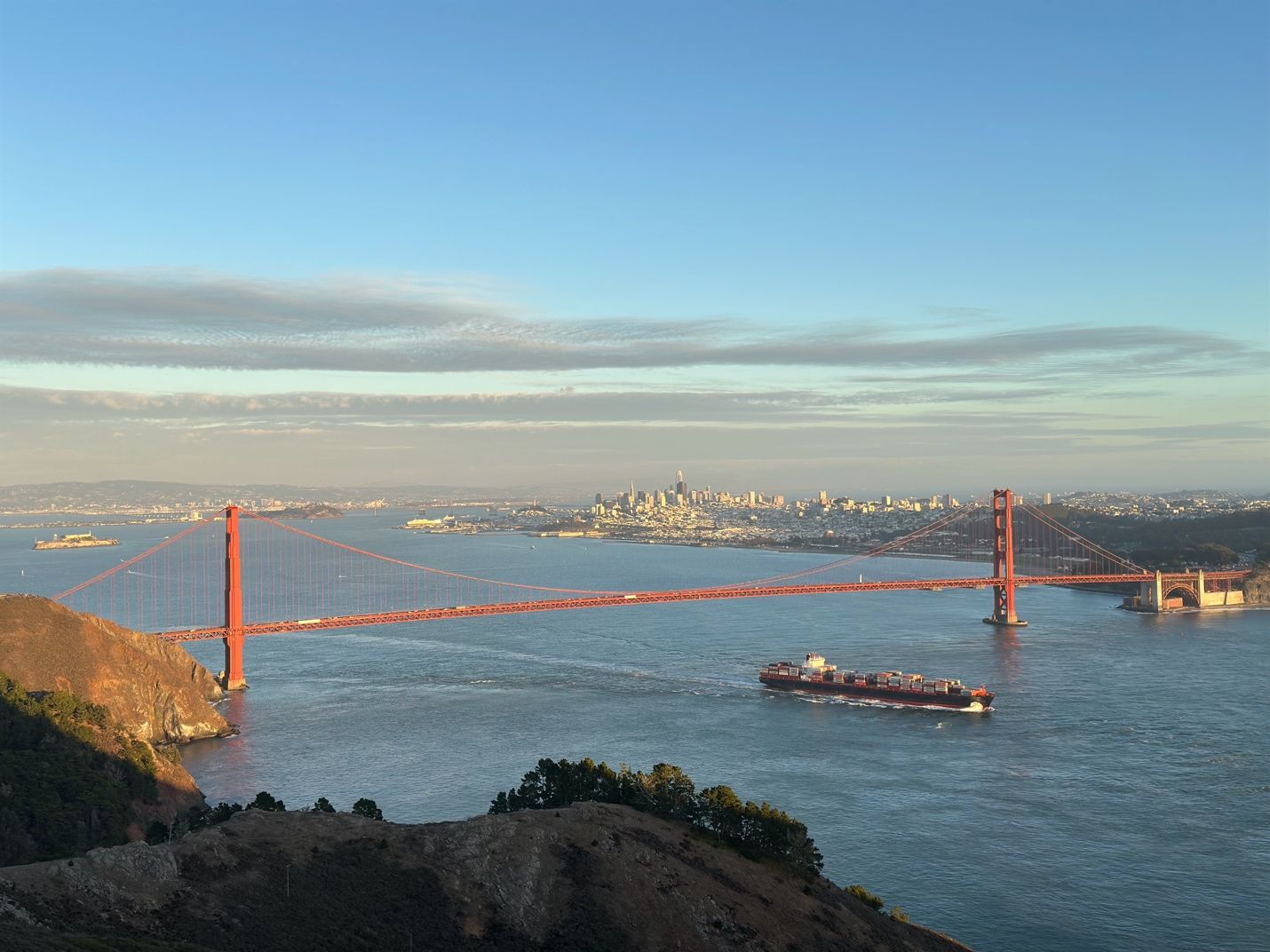 A bridge over water with a ship in the backgroundAI-generated content may be incorrect.